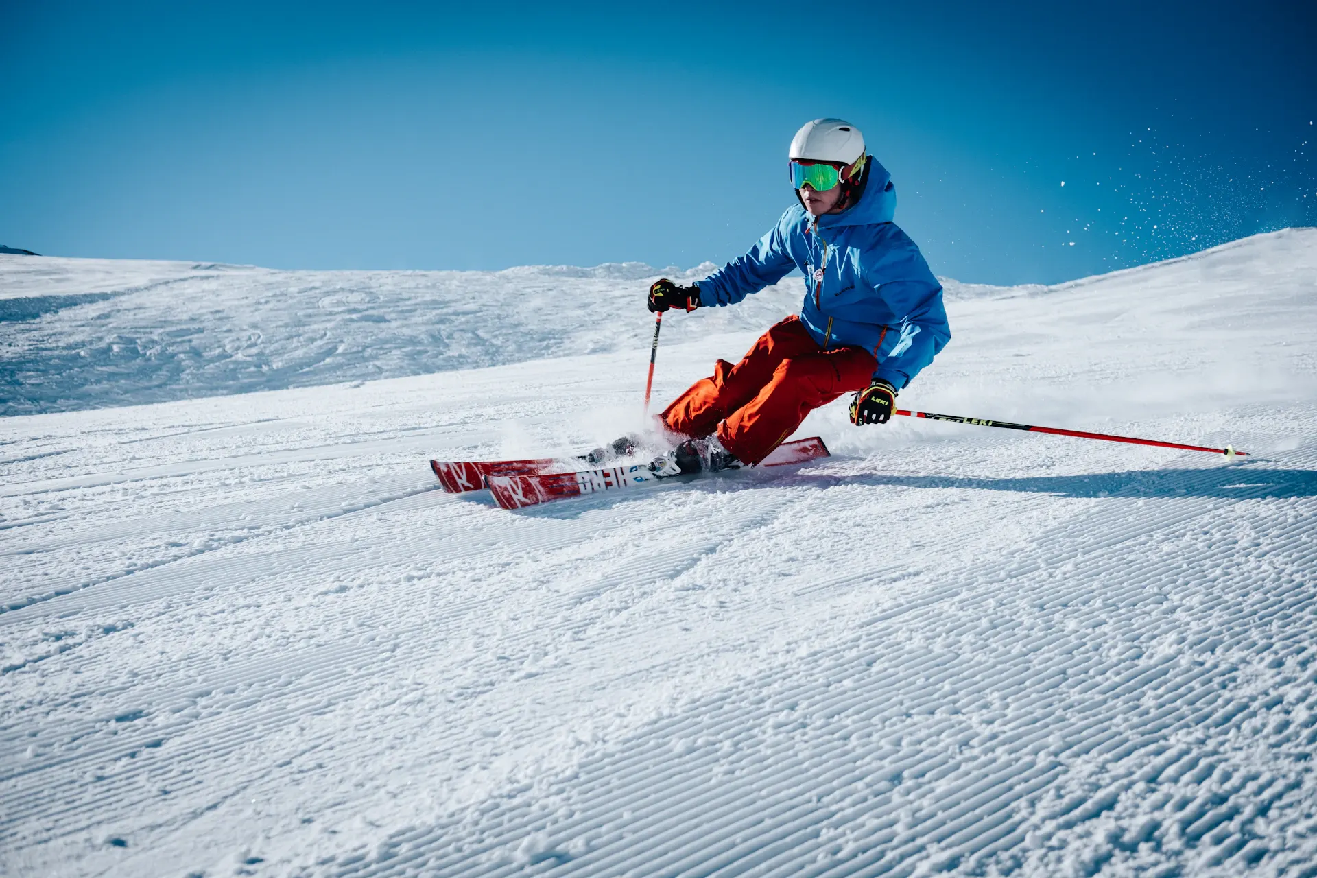 Skier carving down a snow-covered mountain slope